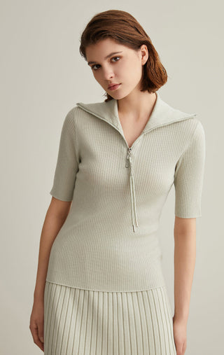Olive green ribbed knit top with short sleeves, zipped mock neck and drawstring tassels