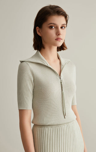 Ivory white wool-silk knit top with half-zip mock neck, short sleeves, ribbed knit