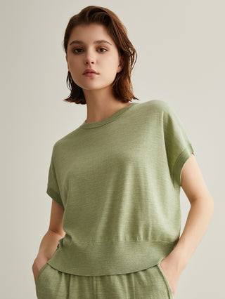 Green short-sleeve knit top with crew neck; beaded side tab detail at hip
