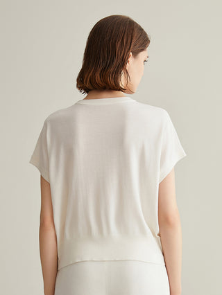 White knit top from back view; short sleeves and smooth drape