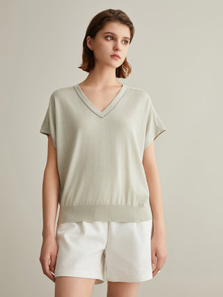 Sage green V-neck silk-wool top with short sleeves and ribbed hem detail