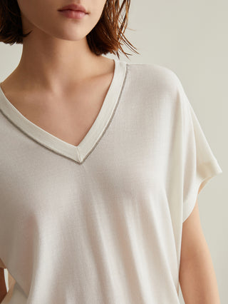 White silk-wool V-neck top with short sleeves and decorative neckline trim