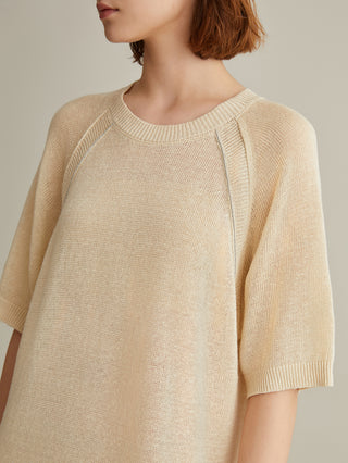 Beige knit dress close-up showing crew neck and vertical seam trim