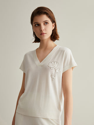 White wool-silk knit top with V-neck and right-chest white floral embroidery, short sleeves
