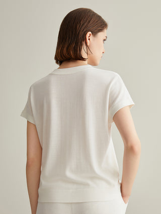 Back view of white wool-silk knit top with short sleeves and simple back hem