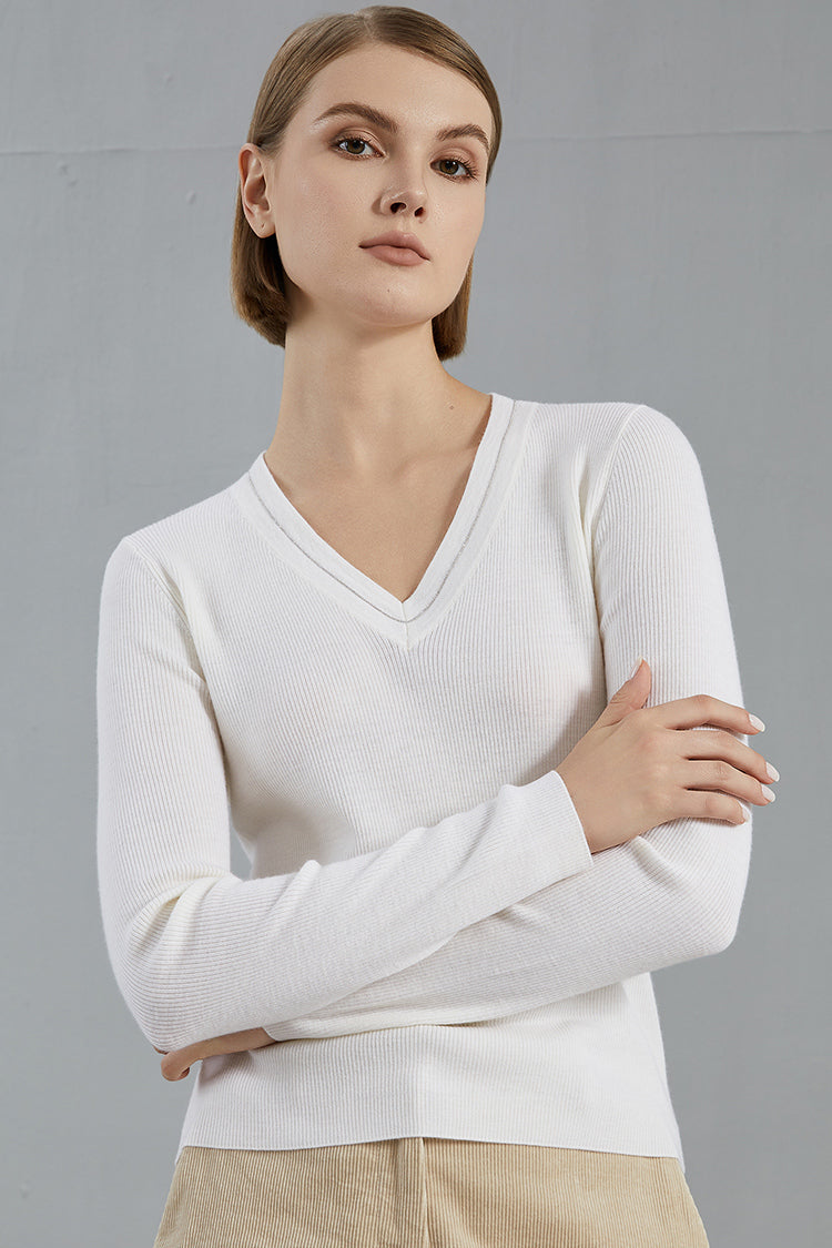 Woman in white shirt under v neck sweater