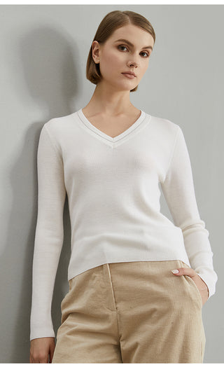 White wool V-neck ribbed knit top, side profile with fitted long sleeves