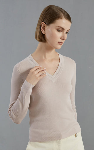 Pale taupe V-neck fine wool pullover, close view of neckline and long ribbed sleeves