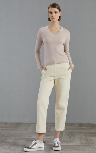 Apricot ribbed wool V-neck knit top with light trousers, full-body view