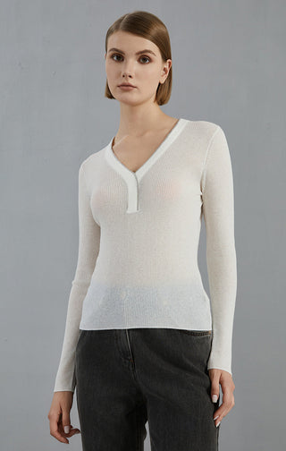 White fine knit V-neck sweater with long sleeves and ribbed hem; fitted silhouette