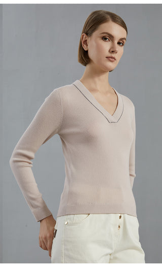 Pale taupe V-neck wool knit top with textured ribbing and long sleeves