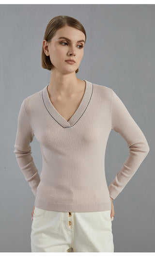 Pale taupe V-neck wool knit top with fitted long sleeves and ribbed hem