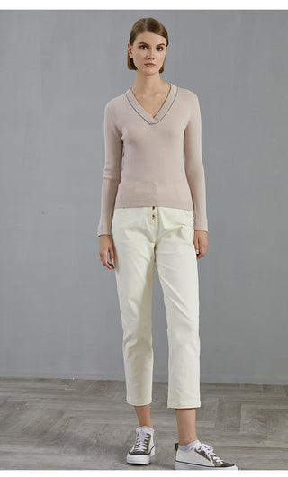 Pale taupe V-neck wool knit top with long sleeves and ribbed cuffs
