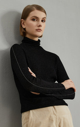 Black ribbed turtleneck top, close-up of high collar and long sleeves