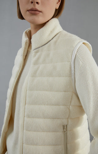 Close-up: white wool vest jacket with stand collar, quilted horizontal panels, zipper pull