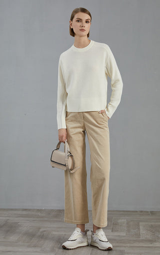 Ivory white fine-rib knit pullover sweater, crew neck, long sleeves; worn with light pants