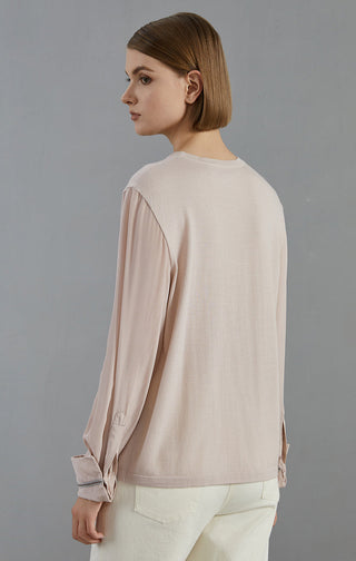 Pale taupe knit pullover from back view; beaded cuff trim and round neckline.