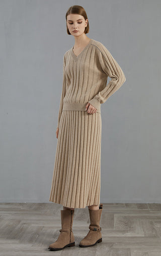 Camel V-neck ribbed cashmere sweater with long sleeves, paired with matching knit skirt