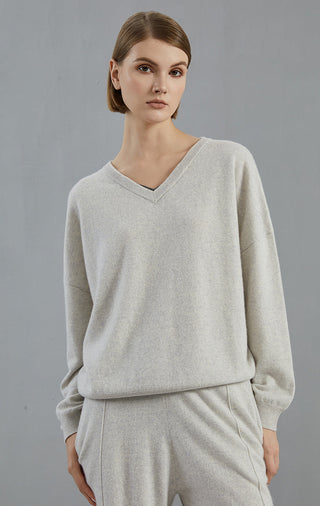 Light gray cashmere v-neck sweater with long sleeves and simple ribbed trim at hem