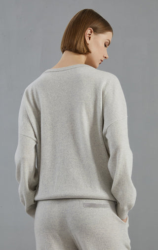 Light gray cashmere v-neck sweater from the back, ribbed hem and long sleeves