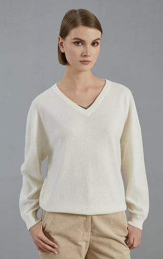 White cashmere v-neck sweater with relaxed fit, long sleeves and ribbed cuffs