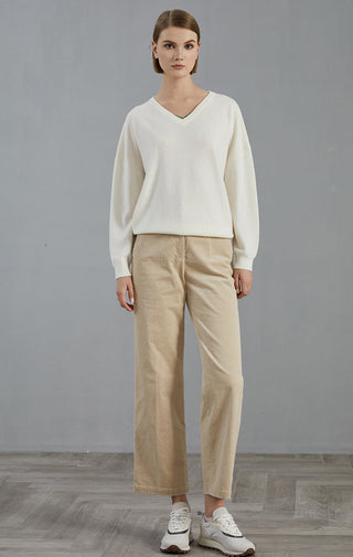 White cashmere v-neck sweater with long sleeves and ribbed trim, full-body view
