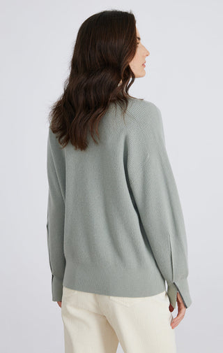 Light green wool ribbed button cardigan back view, textured knit and long sleeves