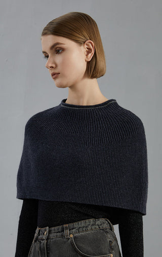 Dark gray wool beanie-knit poncho, ribbed collar, side view with draped shoulders