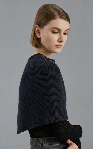 Dark gray wool knit poncho, ribbed crew neck and curved hem, back/side view