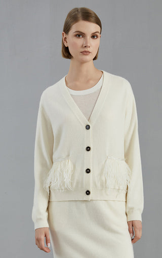 White cashmere cardigan with V-neck and black buttons, feather fringe at cuffs