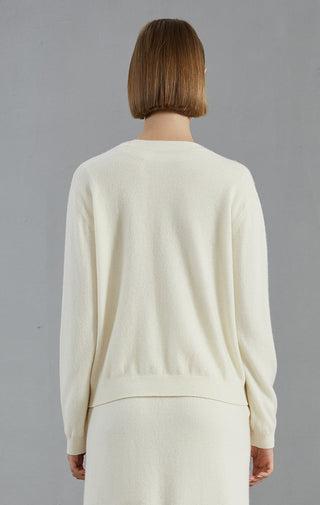 White cardigan back view with smooth yoke seam and long sleeves, cashmere knit