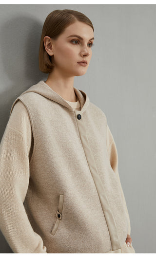 Camel wool hooded vest coat close-up showing hood, button placket, and chest pocket tab