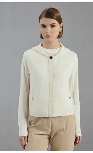 White wool hooded vest coat with button front and side pockets over ribbed knit top