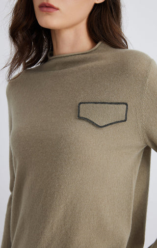 Olive cashmere top close-up: crew neck and stitched silver chain pocket detail