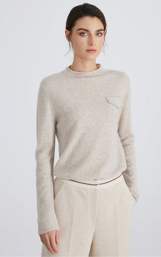 Light gray cashmere knit crewneck top with long sleeves and stitched silver chain pocket detail