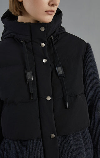 Dark gray hooded down jacket close-up with snap placket, drawstring toggles, and pockets
