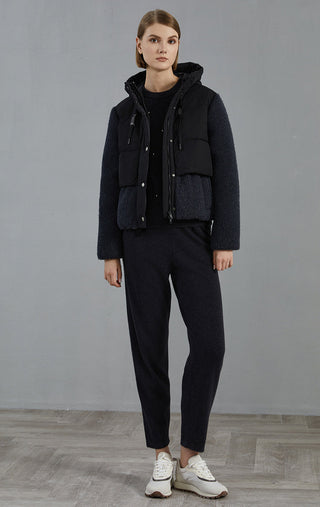 Dark gray hooded down jacket with wool-knit sleeves and snap front; full-body view