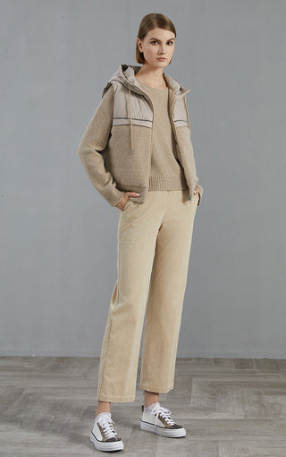 Camel down vest layered over knit top and matching pants; hooded sleeveless outerwear