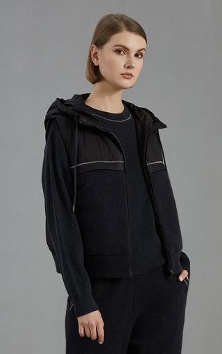 Black hooded down vest with zip front and striped panel seams; knit hem and sleeves