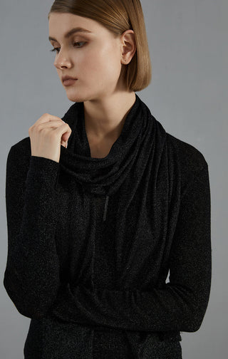 Black scarf wrapped in cowl style at the neckline with long ends across the chest