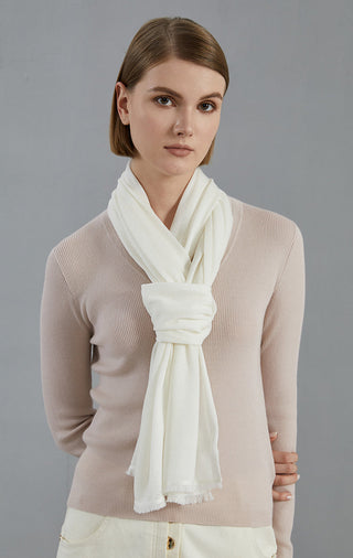 Off-white lightweight wool-blend scarf, draped and tied with soft fringe ends