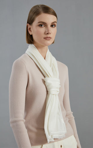 Wool-blend lightweight scarf, off-white, tied at neck with fringed end visible