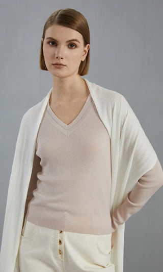 Off-white wool-blend scarf with fringes, worn as a loose wrap across shoulders