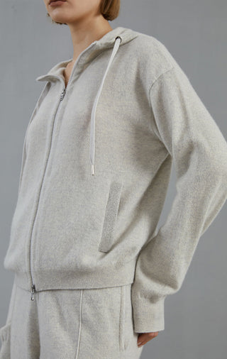 Light gray zip hoodie cardigan, close-up of front zipper and hood drawstrings