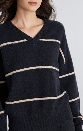 Cashmere V-neck striped sweater close-up with cream bands across chest and sleeves