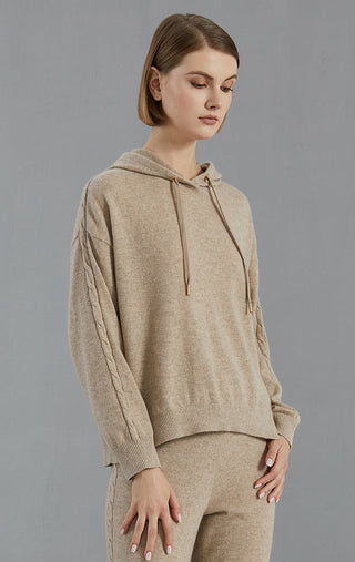Camel hooded cashmere sweater, side view; drawstring hood and cable-knit sleeve detail