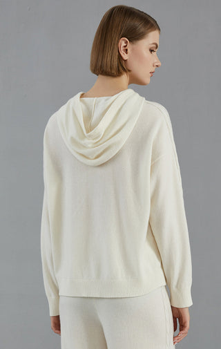 White cashmere hooded sweater, back view; hood drape and textured knit sleeves