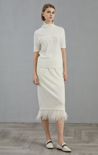 White high-neck short-sleeve sweater with fringe trim along hem and skirt-like bottom