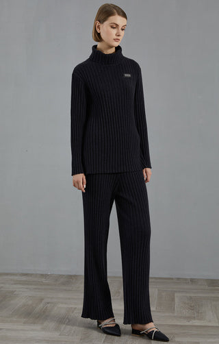 Dark charcoal ribbed turtleneck sweater with matching ribbed pants, logo patch on chest