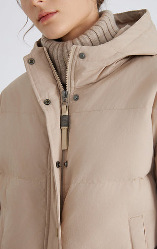 Camel puffer jacket close-up: hooded mock layer, center front zipper, snap buttons